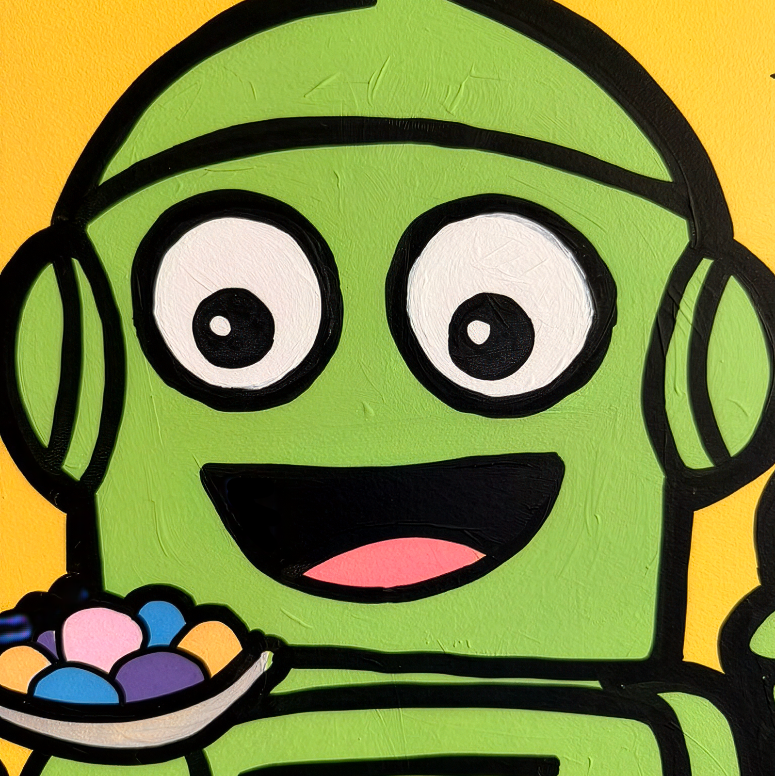 Close-up of a green robot on Robo Pops showing the painted surface
